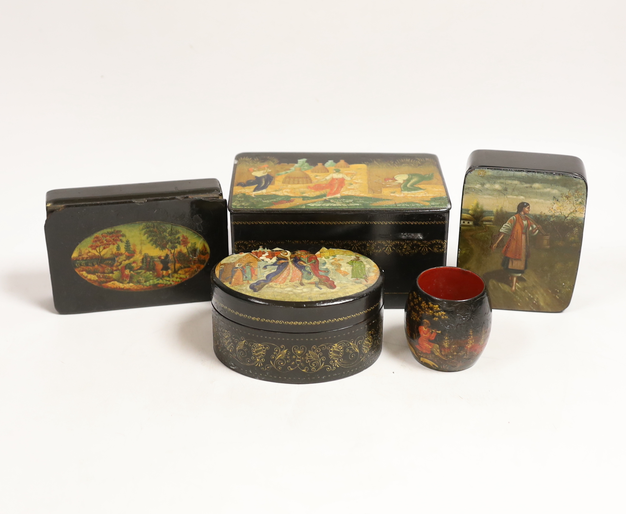 Four Russian lacquer boxes and a similar napkin ring, Palekh and others, the oval box painted with figures from legend and the others with rural scenes, some inscribed with the subject or artist, largest 13.7cm wide (5)